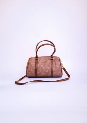 Stylish brown leather handbag with handles and strap on a white backdrop.